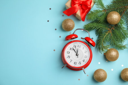 Flat lay composition with alarm clock, gift box and beautiful decorations on color background....