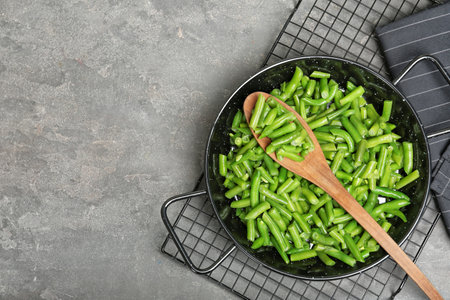 Flat lay composition with frozen green beans on gray background. vegetable preservationの写真素材
