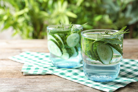 Natural lemonade with cucumber in glasses on tableの写真素材