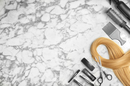 Flat lay composition with professional hairdresser tools on marble backgroundの写真素材