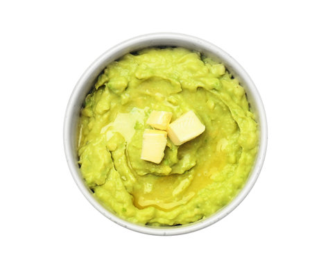 Bowl with guacamole made of ripe avocados on white background, top viewの写真素材