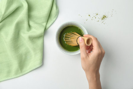 Woman preparing matcha tea at table, top viewの写真素材