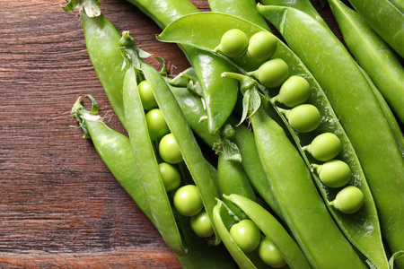 Fresh green peas on wooden background, closeupの写真素材