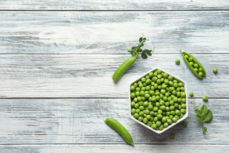 Flat lay composition with green peas on wooden backgroundの写真素材
