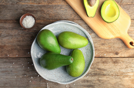 Flat lay composition with ripe avocados on wooden backgroundの写真素材