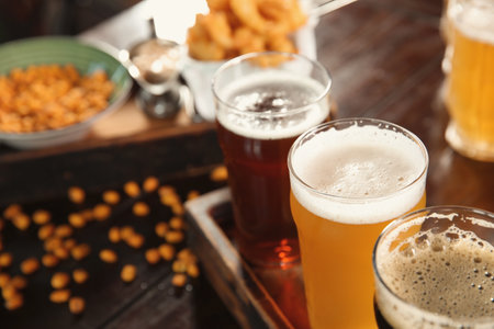 Glasses of tasty beer on wooden table, closeupの写真素材