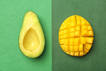 Flat lay composition with ripe avocado and mango on color backgroundの写真素材
