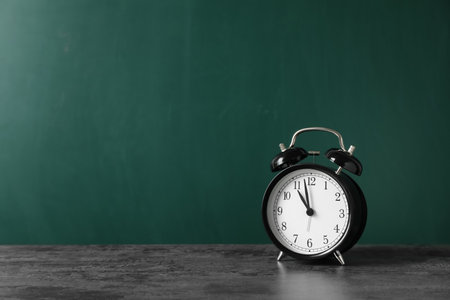 Alarm clock on table against color background. time conceptの写真素材