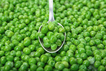 Frozen peas and spoon, closeup. vegetable preservationの写真素材