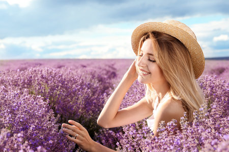 Young woman in lavender field on summer dayの写真素材