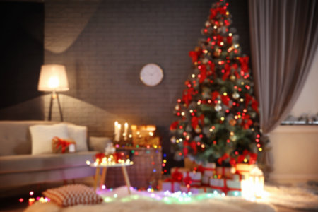 Blurred view of stylish room interior with decorated Christmas treeの写真素材