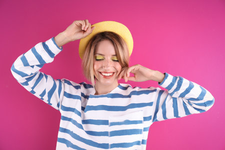 Beautiful young woman posing on color background. summer fashionの写真素材