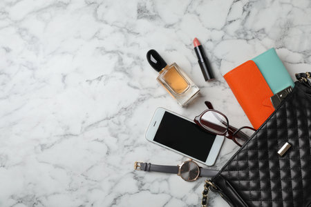 Flat lay composition with stylish bag, wallet and accessories on marble backgroundの写真素材