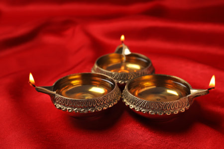 Diwali diyas or clay lamps on color fabric