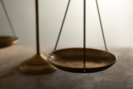 Scales of justice on table, closeup. law conceptの写真素材
