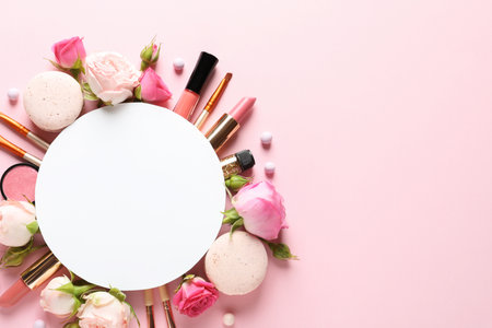 Flat lay composition with card and products for decorative makeup on pastel pink backgroundの写真素材
