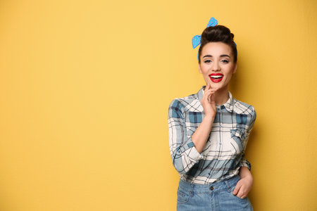 Portrait of funny young housewife on color background