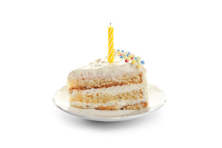 Slice of delicious birthday cake with candle on white backgroundの写真素材