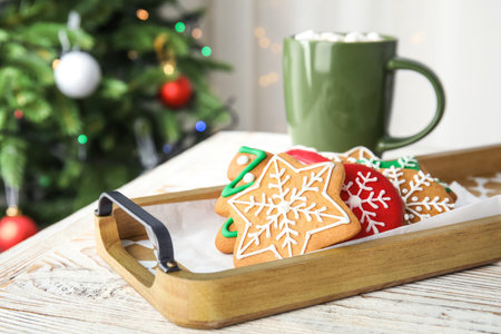 Tray with tasty homemade Christmas cookies and cup of cacao on tableの写真素材