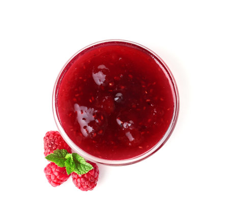 Bowl with delicious raspberry jam on white background, top view