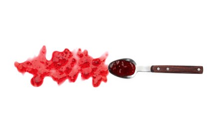 Spoon and sweet raspberry jam on white backgroundの写真素材