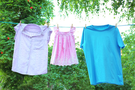 Clothes on laundry line outdoors on sunny dayの写真素材