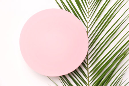 Beautiful composition with tropical leaves on light background, top viewの写真素材