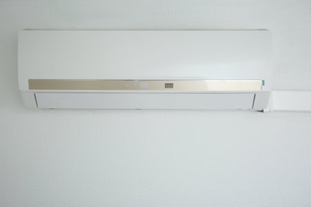 Modern air conditioner on white wall indoorsの写真素材