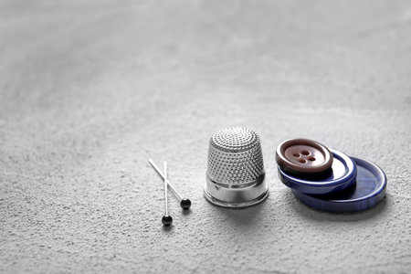 Set of tailoring accessories on gray background, closeup