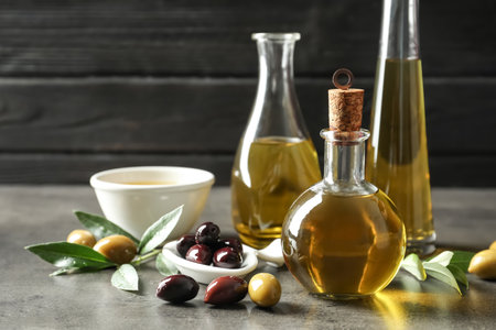 Composition with fresh olive oil on tableの写真素材