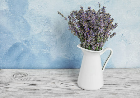 Pitcher with blooming lavender flowers on tableの写真素材