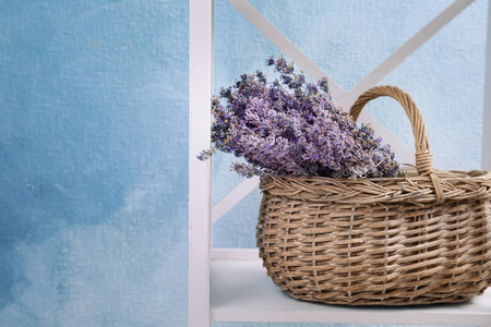 Wicker basket with lavender flowers on shelfの写真素材