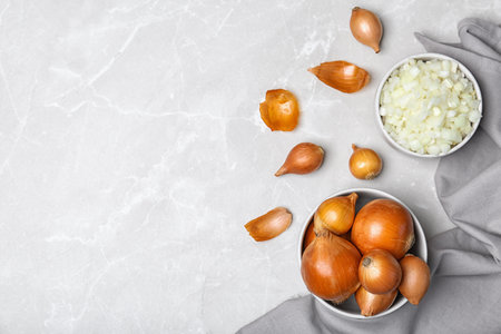 Flat lay composition with fresh ripe onions on tableの写真素材