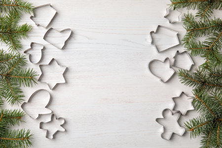 Flat lay composition with cutters for Christmas cookies on wooden backgroundの写真素材