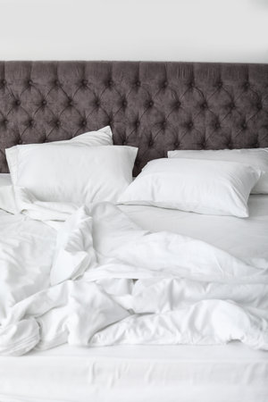 Soft white pillows on comfortable bed, closeupの写真素材