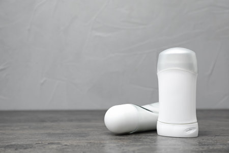 Deodorants on gray table against gray background. skincareの写真素材