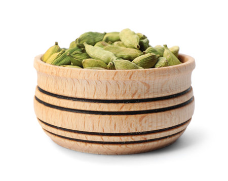 Wooden bowl with cardamom on white background. Different spicesの写真素材