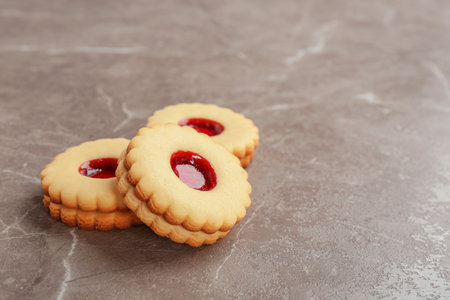 Traditional Christmas Linzer cookies with sweet jam on gray backgroundの写真素材