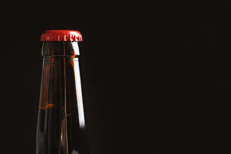Bottle of tasty cold beer on black background, closeupの写真素材