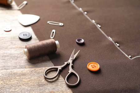Set of tailoring accessories and fabric on wooden backgroundの写真素材