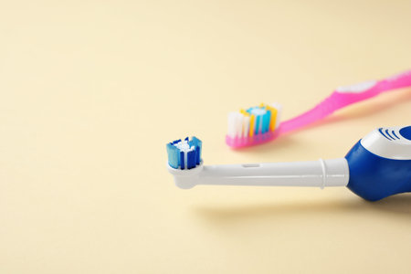 Manual and electric toothbrushes on color background. dental careの写真素材