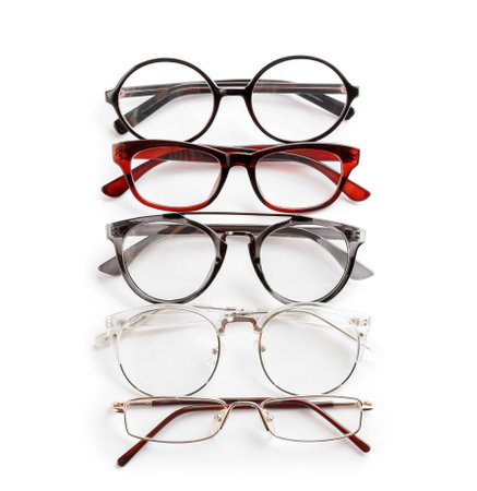Different glasses with corrective lenses on white background. vision problemの写真素材