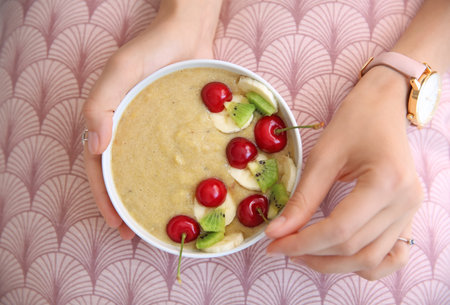 Young woman with bowl of healthy smoothie, closeupの写真素材