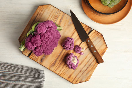Wooden board with purple cauliflower cabbage on table, top view. Health foodの写真素材