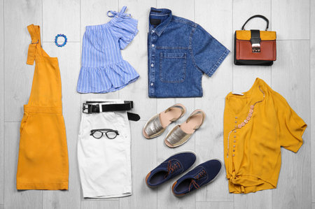 Set of stylish clothes and accessories on wooden floor, flat layの写真素材