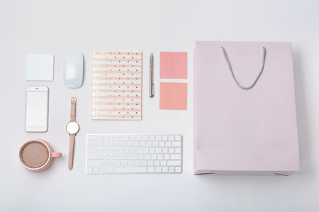 Stylish flat lay composition with shopping bag on white backgroundの写真素材