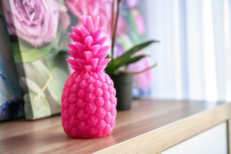 Pineapple shaped candle on table in roomの写真素材