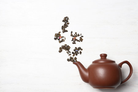 Flat lay composition with dry tea and pot on white backgroundの写真素材
