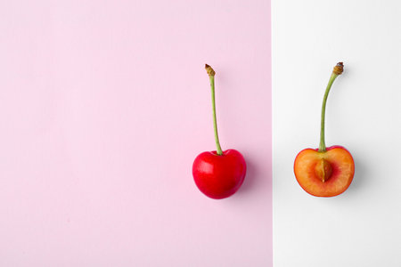 Flat lay composition with ripe red cherries on color backgroundの写真素材