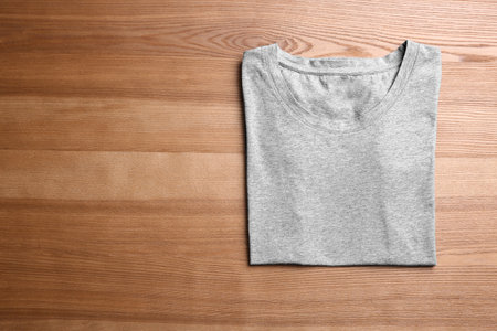 Blank gray t-shirt on wooden backgroundの写真素材
